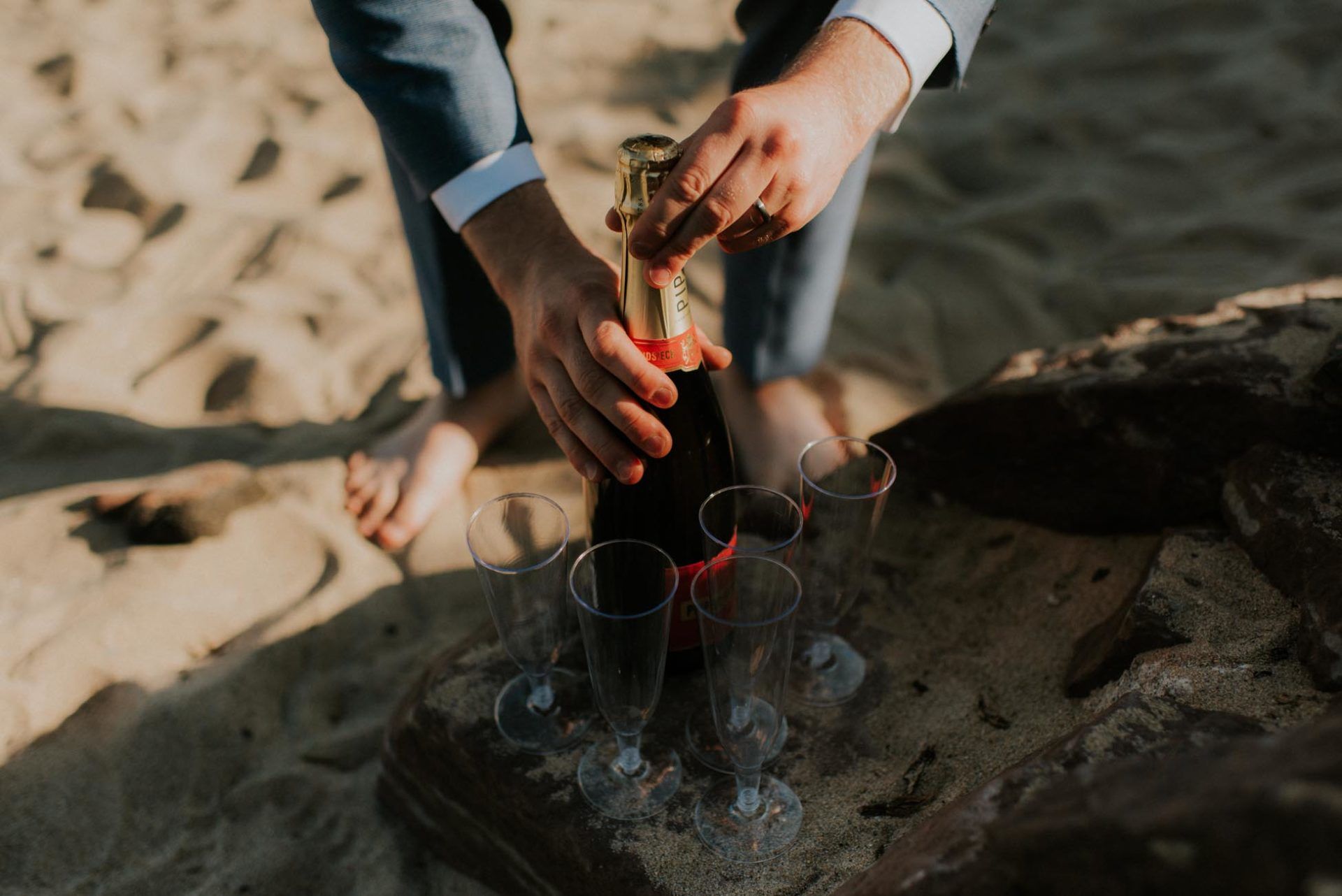 champagne and feet on the beach