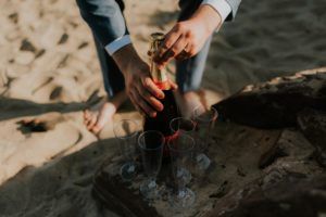 champagne and feet on the beach